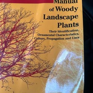 The image displays the book "Manual of Woody Landscape Plants: Their Identificat